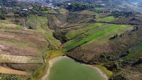 Aerial above lake inside the albanian countryside near Durrës. Scenic hill landscape.