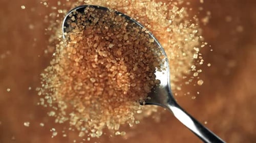 Close Up of Brown Sugar Spilling off Spoon