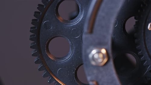 Black Cog Wheels Rotating in Sync