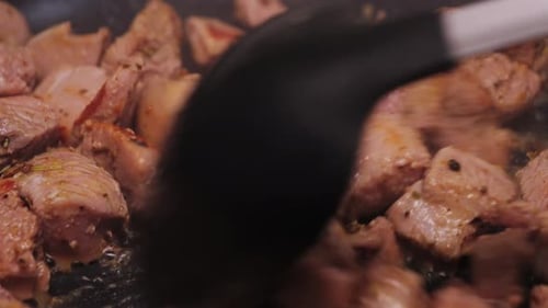 Diced Turkey Meat Being Fried in a Pan Gently Stirred to Cook Evenly