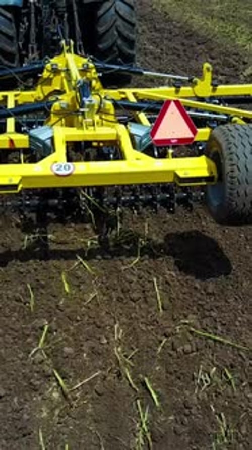 Tractor Working In The Agricultural Field. Agricultural equipment ready for ploughing the fields