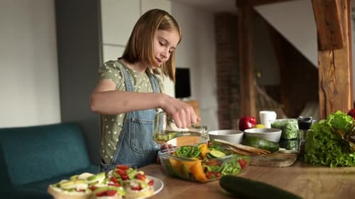 Teen Girl Prepares Salad in Bright Home Kitchen