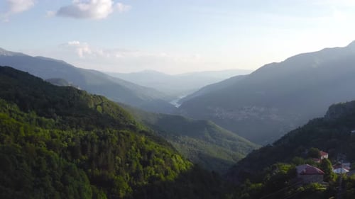 Aerial dolly out revealing a group of friends camping with tents on top of mountain with views to a