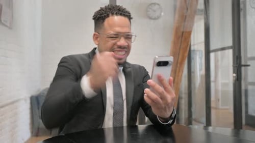 Man in Suit Reacts to Good News on Phone
