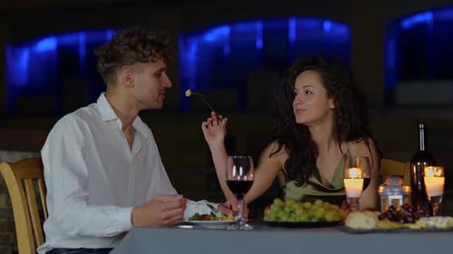 Affectionate Couple Shares Romantic Dinner at Night