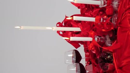 Candle Composition on Candlestick with Red Ribbons Vertical Footage Burning Candles on White