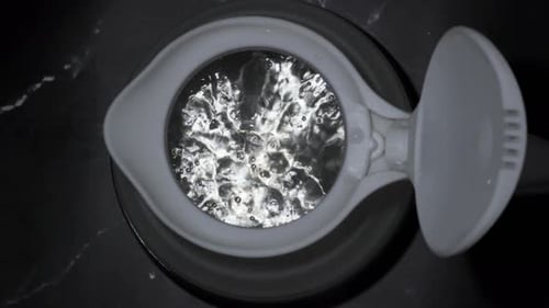 boiling water bubbles comes up in silicone kettle closeup view
