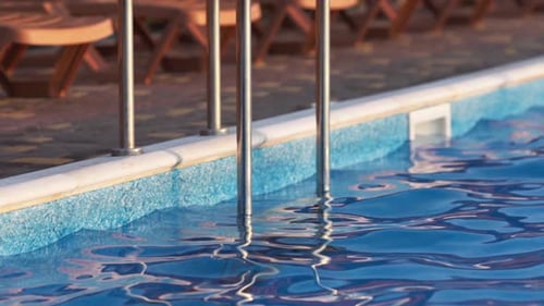 Top View of Swimming Pool with Clear Water on Vacation on Sunset Background