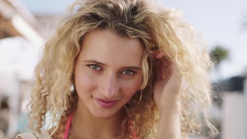 Woman, face or windy curly hair in city travel location, summer break or Spain holiday vacation