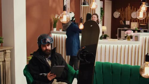 Hotel Guest Uses Digital Tablet in Lobby