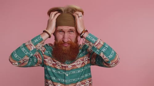 Stressed Bearded Man Holding Head Indoors