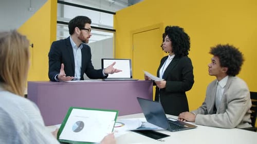 Young Professionals Brainstorming on a Meeting in Modern Office Space