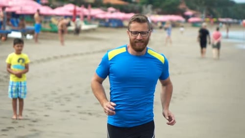 Young Sportive Male Jogging on Beach, Super 240