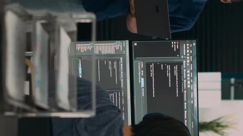 Men Reviewing Code on a Computer Screen