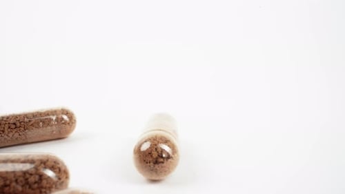 Herbal Supplement Capsules on White Backdrop