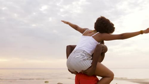 Smiling Couple Having Fun on Beach