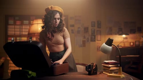 Young Woman in a Beret in Retro Office Comes with Suitcase and Puts It on Table Girl Takes Cameras