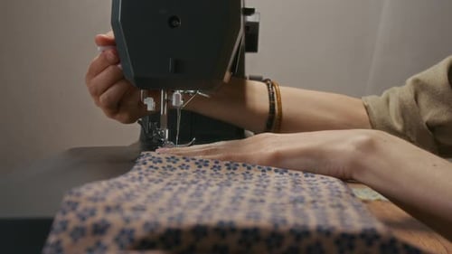 Close Up of Woman Using Sewing Machine Indoors