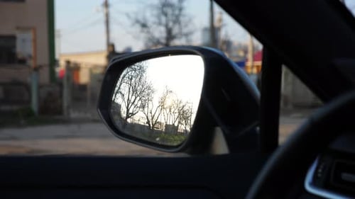 Reflection of a Sunset in a Car Side Mirror Showcasing the Gradual Transition of Light and Shadows