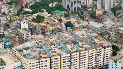 Menschen, die auf dem Dach eines Mehrfamilienhauses in Dhaka City, Bangladesch, spazieren gehen. Abstiegsaufnahme aus der Luft