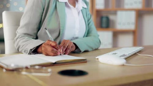 Woman Writing in Notebook at Bright Desk