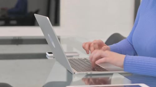 Side View of Female Hands Typing on Laptop