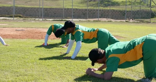 Starting warmup baseball teammates shifting through plank variations on baseball field with markers