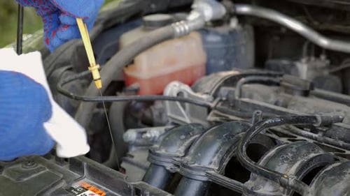 14t. Der Ölstand im Automotor wird mit einem Ölmessstab überprüft
.