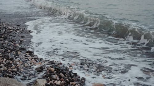 Shore By the Sea at Dusk Tidal Waves Pass Through the Rocky Shore Slow Motion