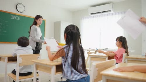 Group of student learn with teacher in classroom at elementary school.