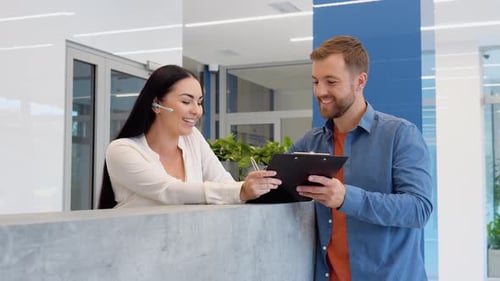 Woman Reception Consultant Helps the Client of Business Center