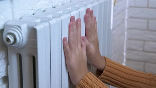Warm Hands Near Heating Radiator