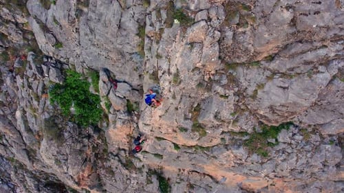 Group Rock Climbing on Vertical Cliff