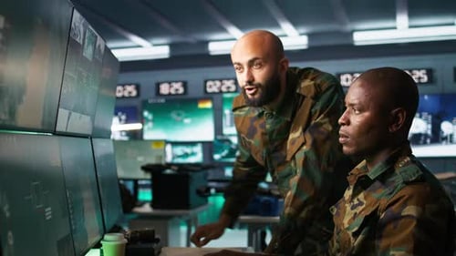 Men in Military Gear Analyzing Computer Screens