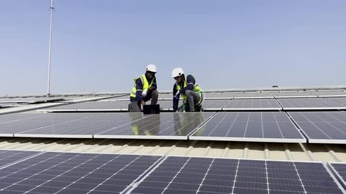 Technician installing solar cell. Installation and maintenance of solar cells on rooftop.