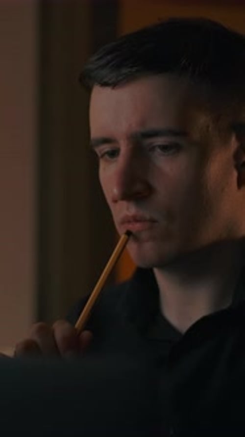 Vertical of A Man Teaches a Lesson Thinks and Makes a Note in a Text Tablet