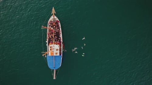 Aerial view of people jumping off the boat in La Valletta, Malta.