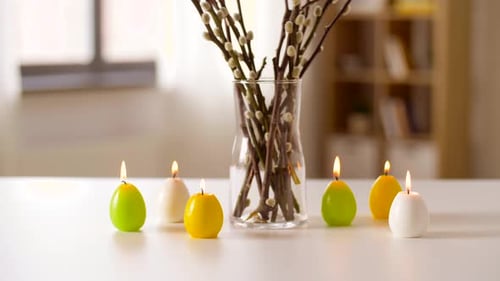 Easter, Religious Holidays and Traditions Concept - Burning Candles in Shape Of