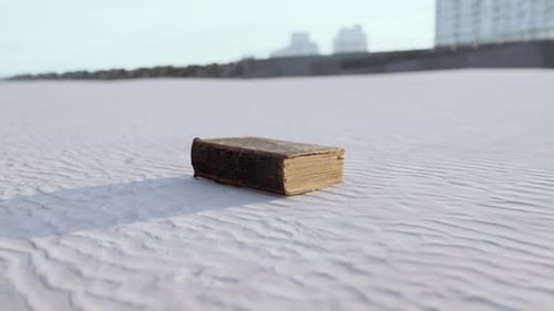 Old Book on the Sand Beach