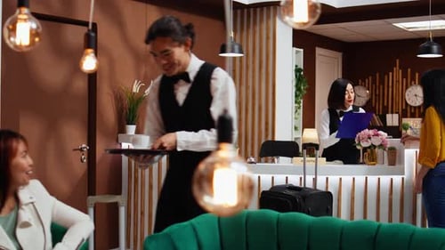 Hotel Receptionist Assists Guest in Modern Lobby
