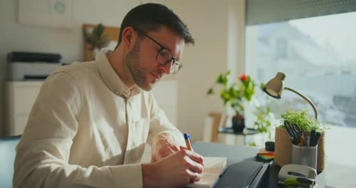 Businessman Taking Notes While Working In Office