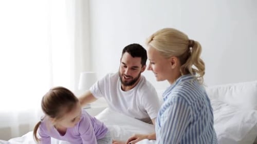 Family Having Fun Jumping on Bed Together
