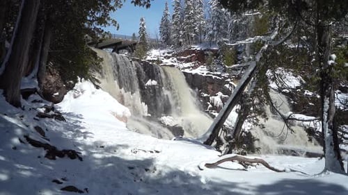 Cascading Waterfall And Snow-covered Trail At Gooseberry Falls State Park On Winter Day. Minnesota,