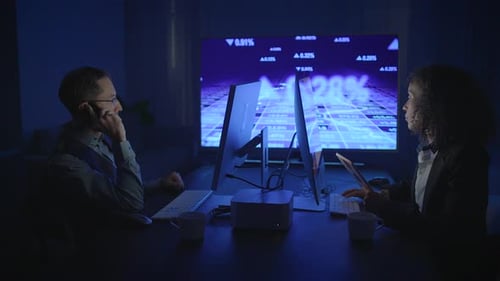 Business Professionals Engaged in Analyzing Data Within a Contemporary Office Environment