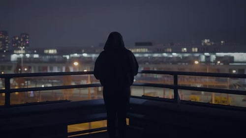 Hooded Fearless Woman Walking in Abandoned Urban Town at Twilight Light