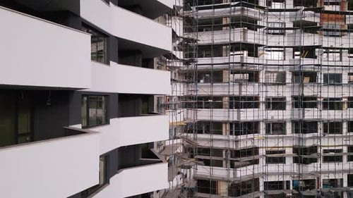 Modern Architecture Under Construction in a Vibrant Urban Environment with Scaffolding and Sleek