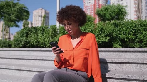 Woman Using Smartphone Sitting on Urban Steps