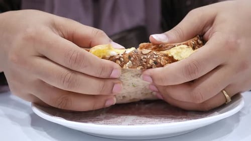 Egg Salad Sandwich Being Cut in Half