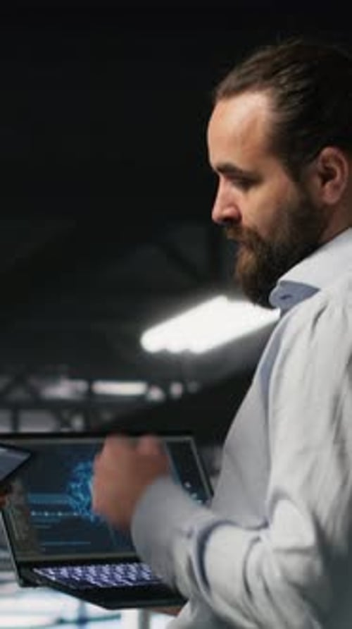 Vertical Video Data Center Team Leader and Worker Reviewing Performance Dashboards of AI