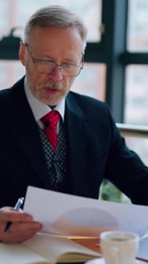 Man Reviews Financial Data in Office Setting